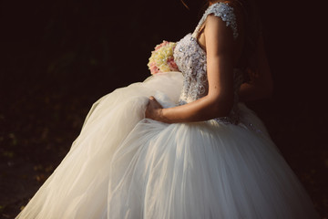 bride holds her wedding dress