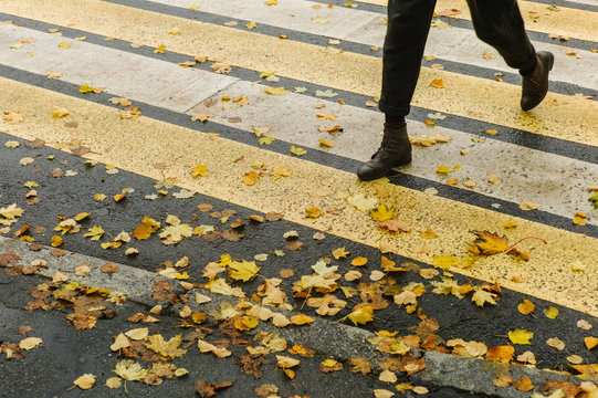 Person crossing street in autumn
