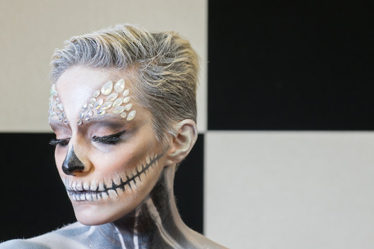 Girl Painted as an Skeleton. Halloween's Make-up. 