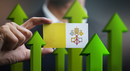 Nation Growth Concept, Green Up Arrows - Businessman Holding Card of Vatican City Flag