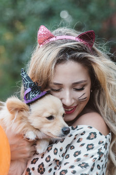 A teenage girl and her dog dressed up for halloween