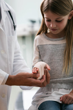 Exam: Doctor Works On Sprained Wrist On Girl Patient