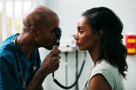 Exam: Doctor Checks Patient Eyes With Ophthalmoscope