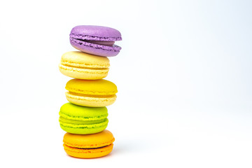 Colorful french macarons on white background.