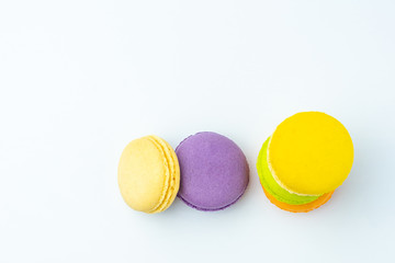 Colorful french macarons on white background.