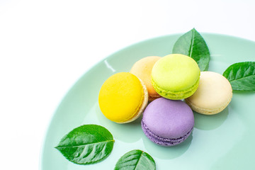 Colorful french macarons on white background.