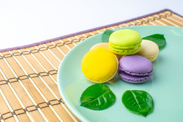 Colorful french macarons on white background.