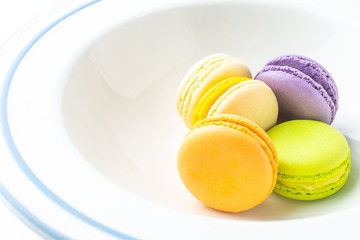 Colorful french macarons on white background.