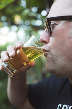 Man enjoying a beer in backyard during summer