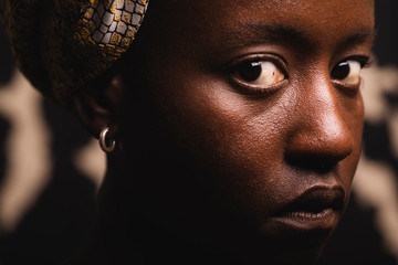 Portrait of a black girl with an intense look, close up.