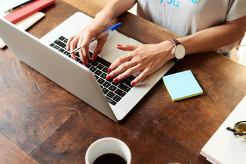 Woman with pen at laptop