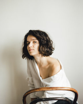 girl is posing on a chair