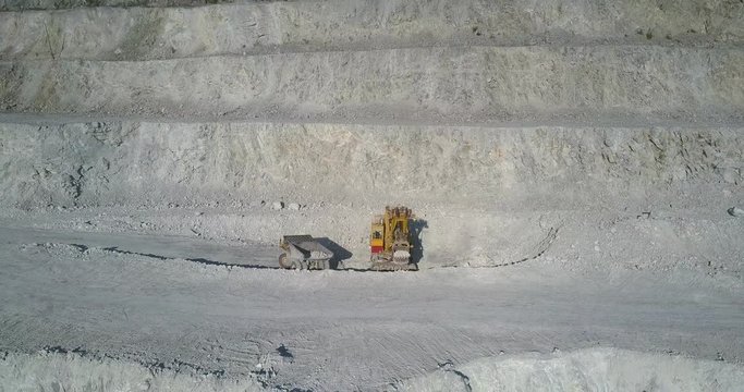 powerful shovel loads tipper truck with asbes in quarry