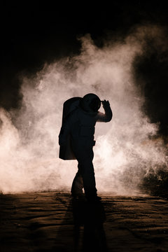 Astronaut walking in smoke