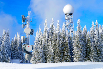 Telecom radar station in the snow in winter time on a sunny day