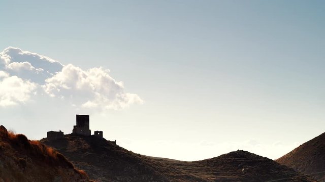 Greece Mani Peninsula. Traditional style stone tower house on hill against sky. Laconia Peloponnese, Europe. Time lapse 4K