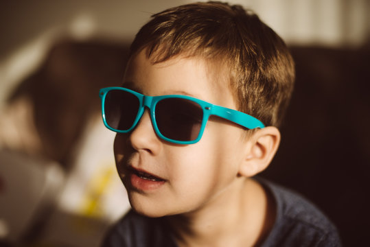 Boy with a sunglasses on direct sunlight 
