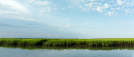 marsh grass and coastal barrier island inlet at high tide
