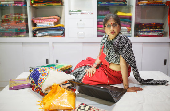 A Businesswoman using laptop for her small business of selling traditional Indian Clothes