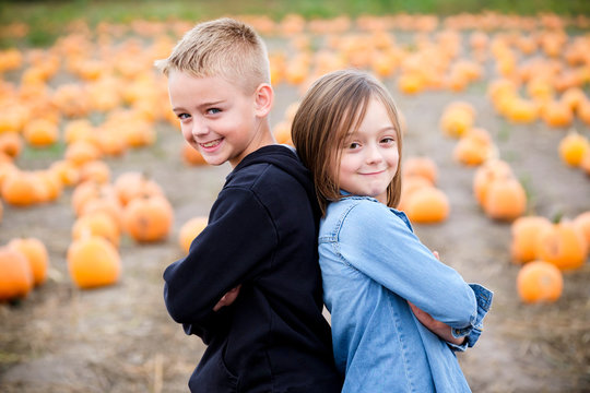 Siblings in a pumpkin patch