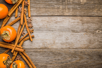 Fresh persimmon fruit on wooden table. Selective focus. Shallow depth of field.
