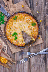 Traditional corn casserole with cheese. Below the corn - parsley mix is ground cheese, olive, egg, baked onion, garlic