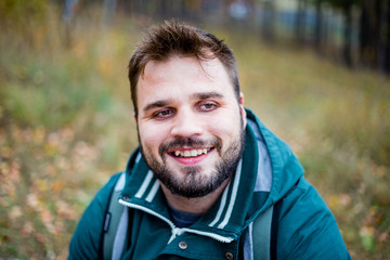 handsome male tourist hiking in the forest