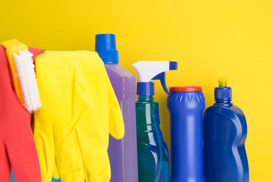 set of items for cleaning and rubber gloves, on a yellow background