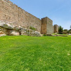 Fototapeta na wymiar Grass lawn and ancient wall of old city Jerusalem