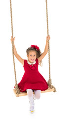 Little girl swinging on a swing
