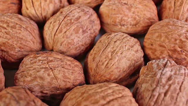 Walnut texture. Brown big whole walnuts as background. walnut nuts pattern close up photo.