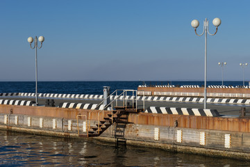 Seascape with pier and beautiful lanterns in the sky.