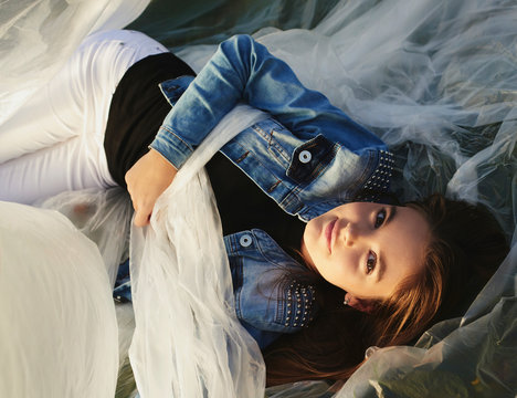 Young girl playing in plastic warp outdoors
