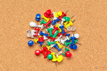 Group of thumbtacks  on corkboard close up. School or business concept