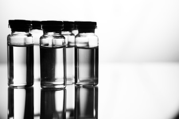 Group of ampoules with a transparent medicine in medical laboratory