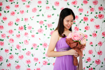 Obraz na płótnie Canvas Bride in dress holding wedding bouquet of flowers and greenery,Happy wedding concept.