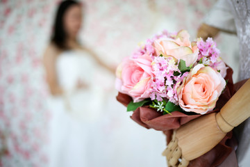 Bride in dress holding wedding bouquet of flowers and greenery,Happy wedding concept.