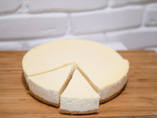 Composition with tasty cheesecake on wooden table