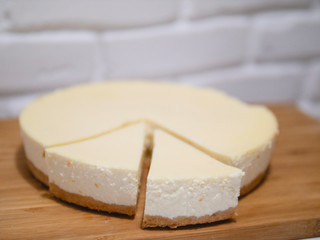 Composition with tasty cheesecake on wooden table