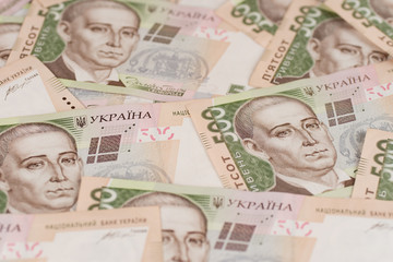 A close-up of a pattern of many Ukrainian currency banknotes with a par value of 500 hryvnia. Background image on business in Ukraine.
