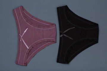 Beautiful women's cotton panties on gray background.