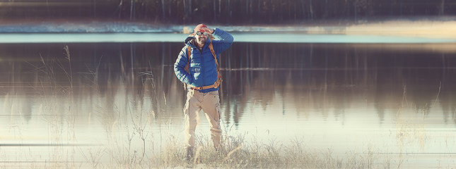 Fototapeta premium man hiking backpack background blurred / long background, nature male leisure alone