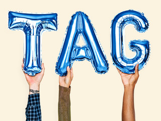 Blue alphabet helium balloons forming the text tag