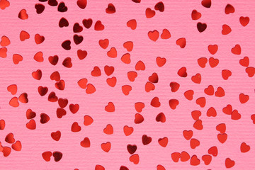 Pink background with red confetti hearts for Valentine Day	
