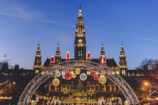Vienna, Austria - December 24, 2017. Traditional Christmas market in front of the Rathaus City hall of Vienna. Xmas fair decorated with lights and Viennese town-hall on the Rathausplatz square.