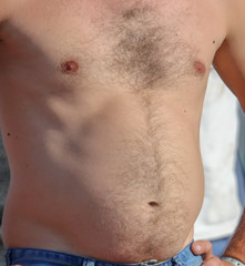 Naklejka premium A man with a hairy chest and stomach as background