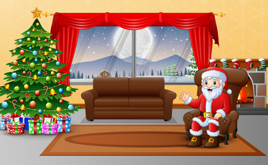 Santa claus sitting in sofa near decorated pine tree