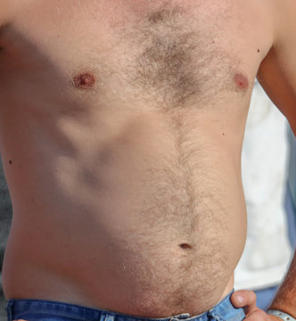 A Man With A Hairy Chest And Stomach As Background