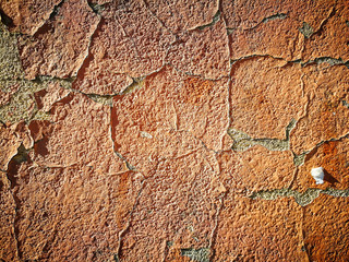 Old cracked wall with orange paint as background