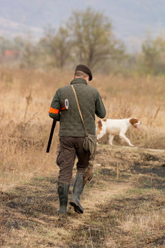 The hunter in the hunting clothes and with rifle hunts